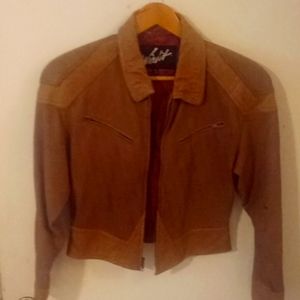Woman's tan leather jacket. Waist length, zippered front, pockets, and sleeves
